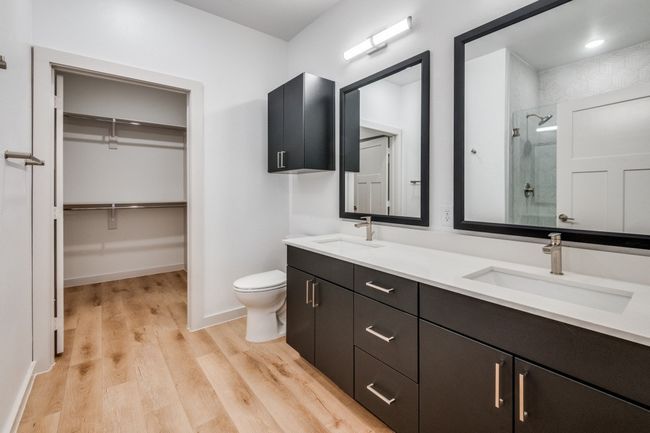 Full bathroom with a sink, a spacious closet, wood finished floors, and a shower stall | Image 20