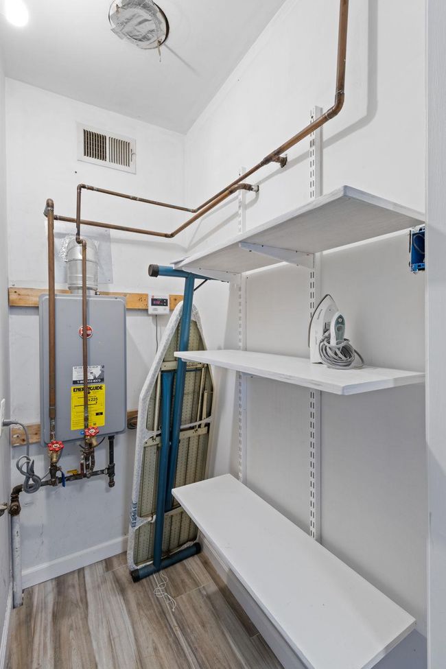Utilities with visible vents and water heater | Image 10