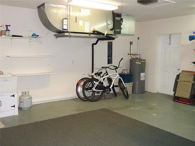 oversized garage 20.9x20 with railing, sink, side door access to attic | Image 58