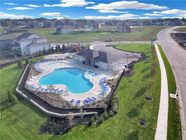 Community pool featuring a fenced backyard, a residential view, and a patio area | Image 20