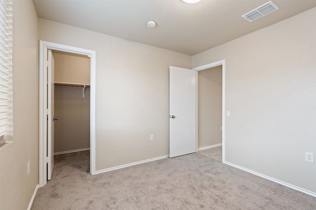 Unfurnished bedroom with carpet and a spacious closet | Image 26