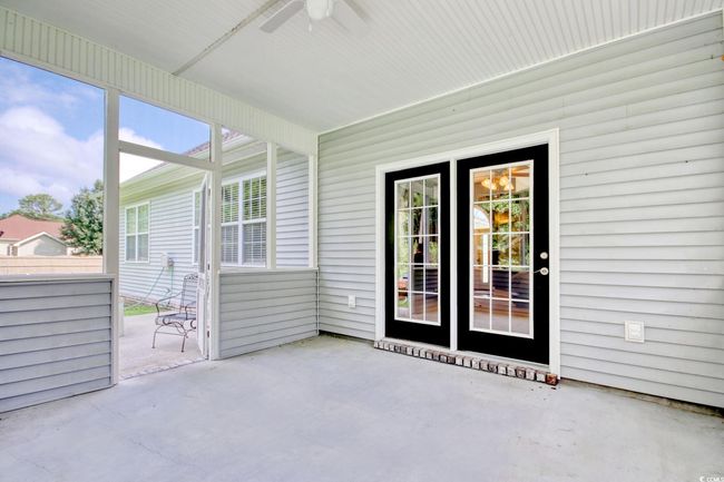 Unfurnished sunroom featuring ceiling fan and plenty of natural light | Image 26