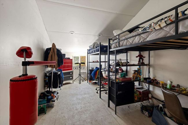 Bedroom featuring concrete floors | Image 30