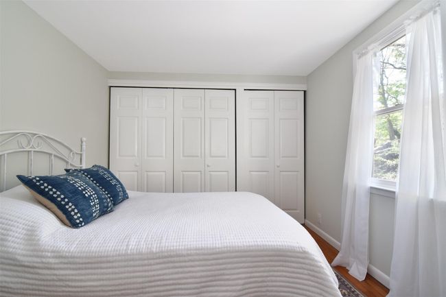 Bedroom with wood finished floors, a closet, baseboards, and multiple windows | Image 14