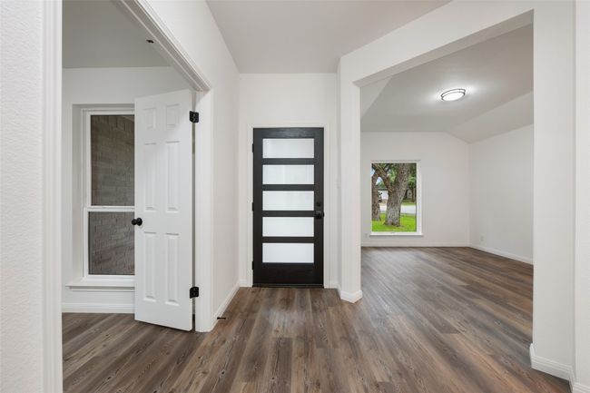 Entrance foyer featuring dark wood-style floors and vaulted ceiling | Image 4