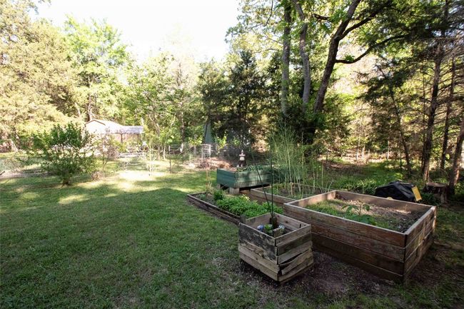 View of the yard featuring a vegetable garden | Image 10