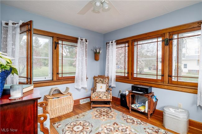 Sitting room featuring ceiling fan, baseboards, wood finished floors, and visible vents | Image 11