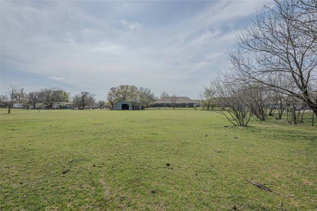 View of yard with an outbuilding, fence, and a rural view | Image 29