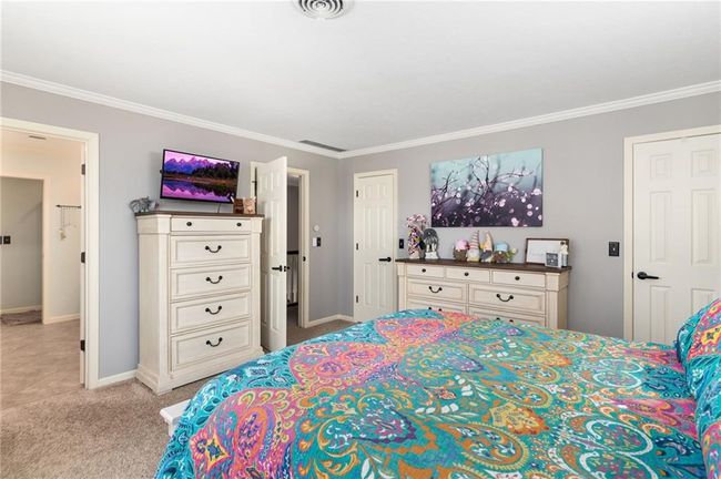 Carpeted bedroom with crown molding | Image 29