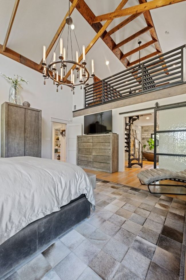 Bedroom featuring a towering ceiling and a chandelier - reading loft above bathroom | Image 24