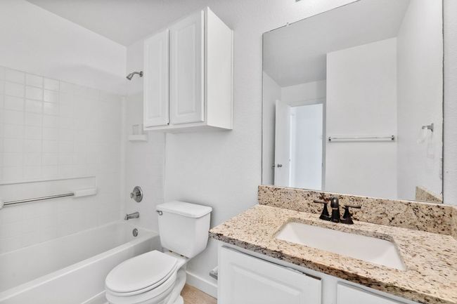 Bathroom with vanity, toilet, and washtub / shower combination | Image 36