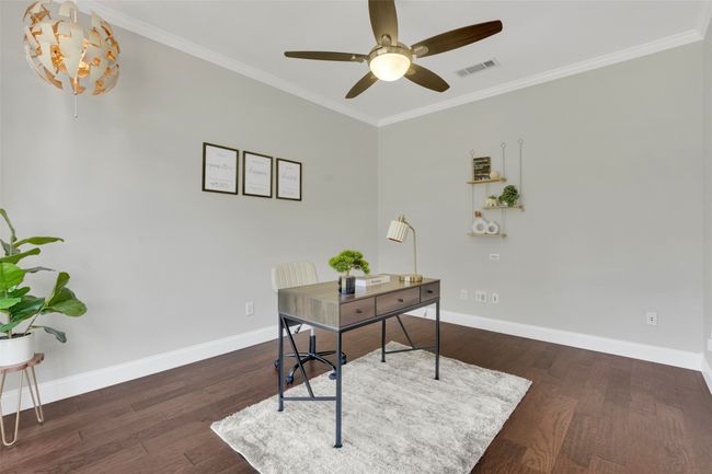 Home office featuring ceiling fan, crown molding, and wood finished floors | Image 5
