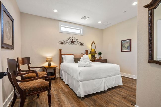 Bedroom featuring dark wood-style flooring, baseboards, and recessed lighting | Image 37