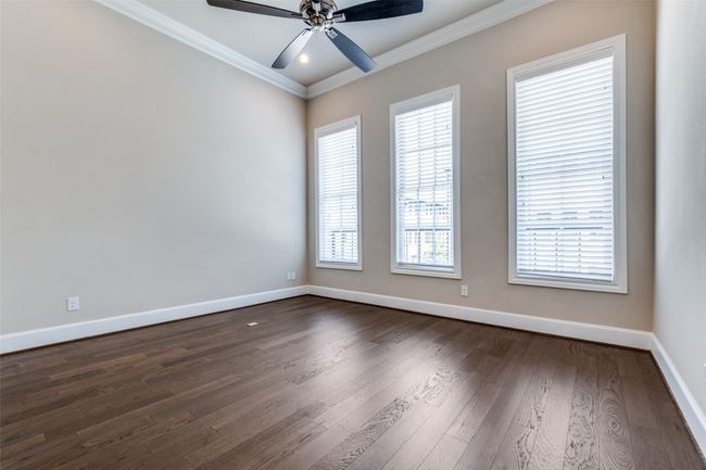 Living area with ornamental molding, dark wood finished floors, and a ceiling fan | Image 20