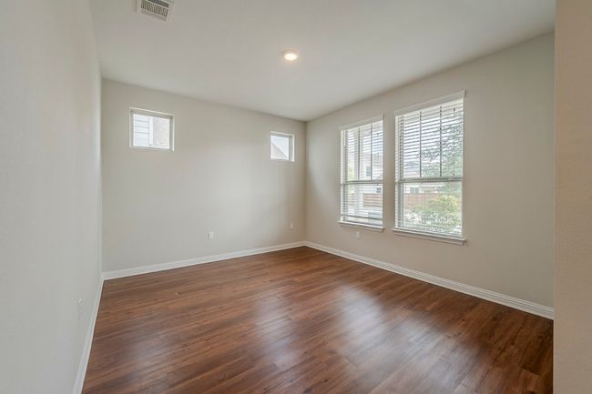 Empty room with visible vents, baseboards, and dark wood-style flooring | Image 21