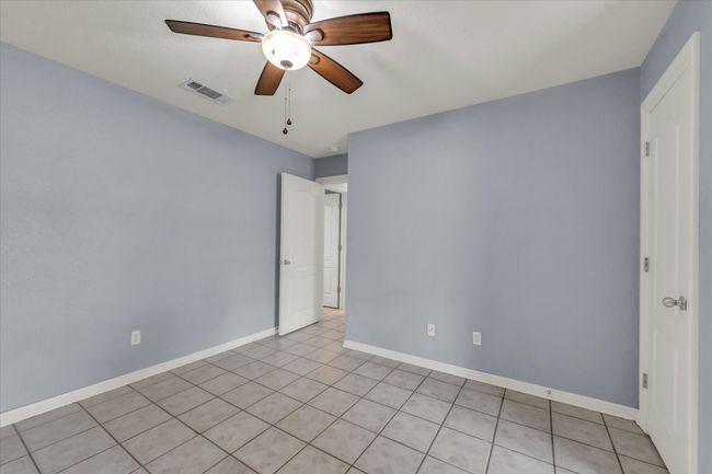 Spare room with ceiling fan and light tile patterned floors | Image 29