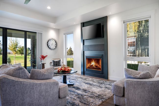 Bright Living room with gas fireplace leading to covered patio and views of the golf course | Image 7
