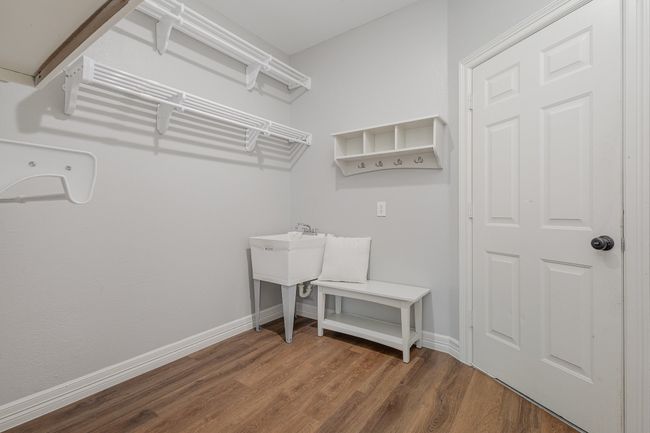 Laundry area with sink, storage shelves, room for full size washer/dryer, drip dry area | Image 15