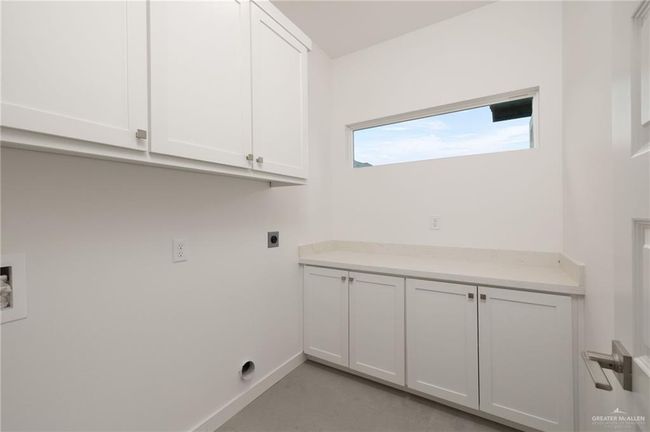 Laundry area with electric dryer hookup, cabinet space, and hookup for a washing machine | Image 15