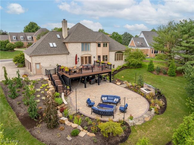 Take a look at this back patio that is new and the tiered deck that heads down to the patio. Notice the covered porch. This is a private oasis. | Image 4