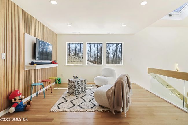 A healthy sunlit gaming/play area w skylights and many windows | Image 19
