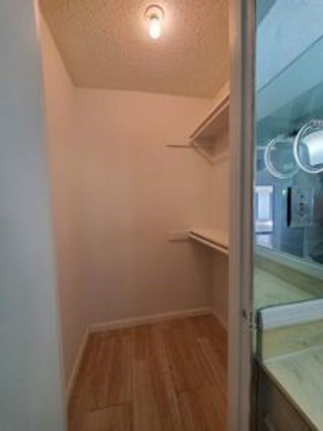 Spacious closet featuring wood finished floors | Image 32