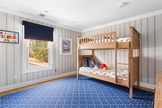 Bedroom with visible vents, wood finished floors, baseboards, and crown molding | Image 38