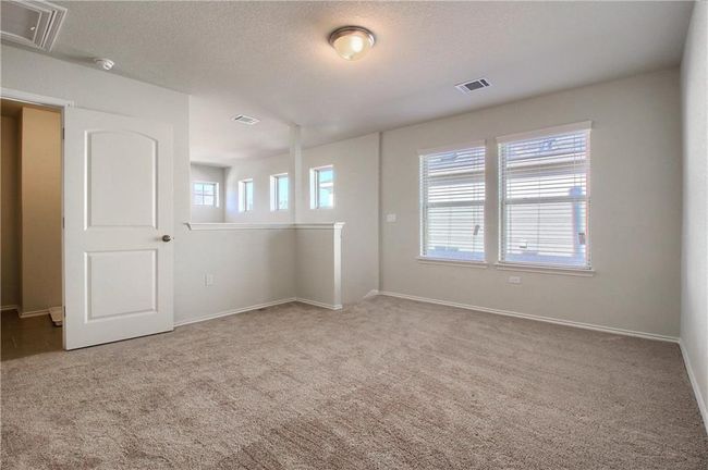 Carpeted empty room with baseboards and a smoke detector | Image 18