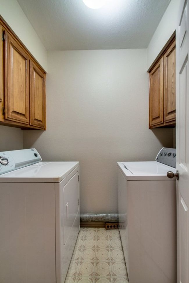 Laundry area featuring separate washer and dryer and cabinet space | Image 8