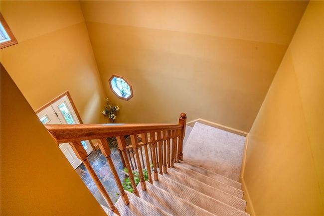 Stairs with carpet flooring and a towering ceiling | Image 21