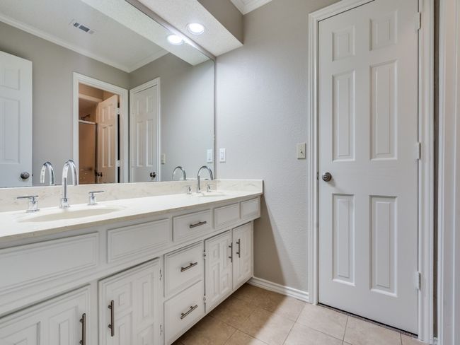 Full bath between bedrooms 3 and 4, with two sinks, and separate door to shower and toilet. | Image 29