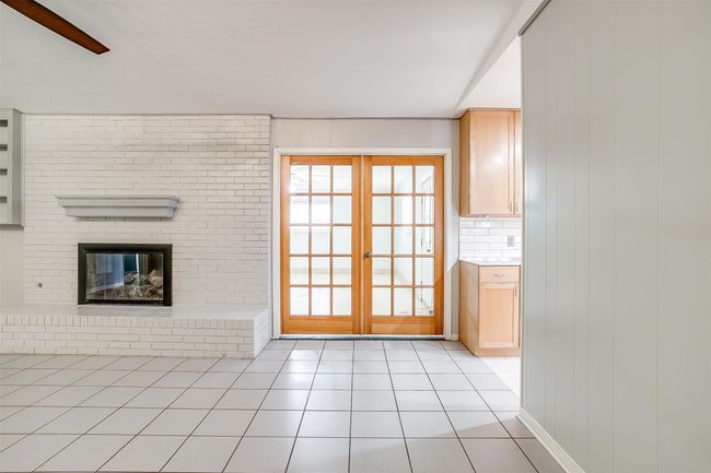 A view of the spacious bonus room with french doors | Image 13