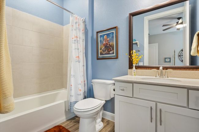 En Suite Bathroom with wood look tile flooring, vanity, framed mirror & shower / bath combo | Image 27