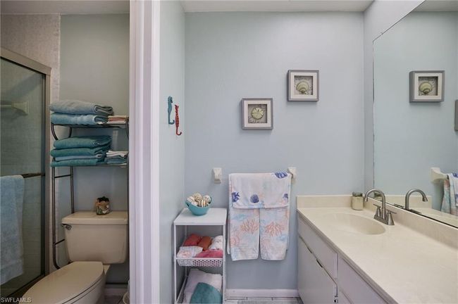 Bathroom featuring vanity, toilet, and a shower with shower door | Image 16