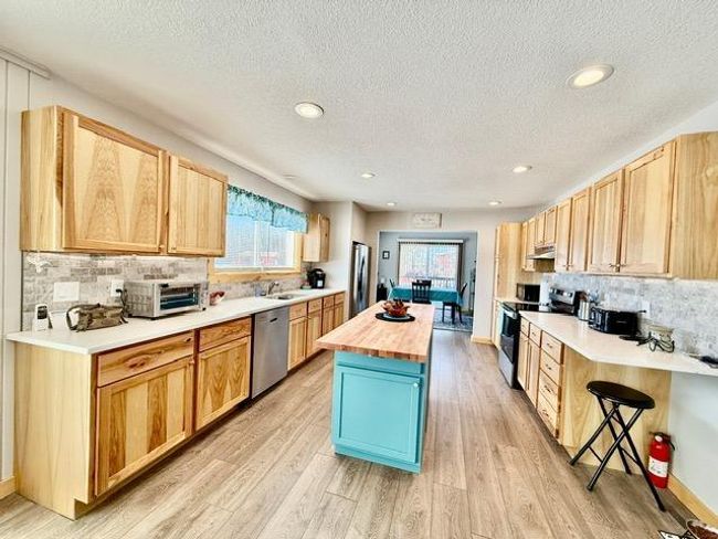 Hickory cabinets, quartz counters, tile back splash, new sink, lighting and appliances | Image 15