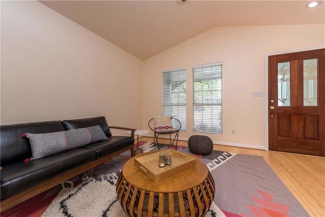 Living area featuring lofted ceiling and wood finished floors | Image 17
