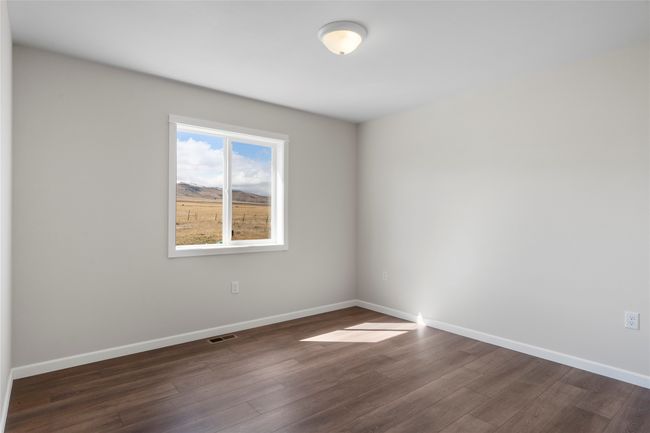 Spare room with dark wood-style floors, baseboards, and visible vents | Image 51