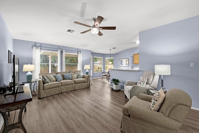 Living room featuring ceiling fan, and lofted ceiling | Image 4