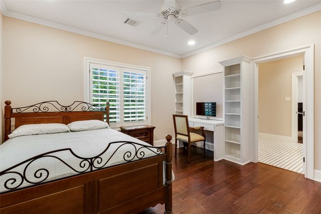 Bedroom with ornamental molding, dark wood finished floors, baseboards, recessed lighting, and ceiling fan | Image 14