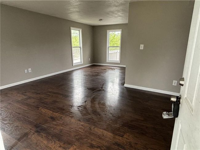 Empty room with dark wood finished floors and baseboards | Image 6
