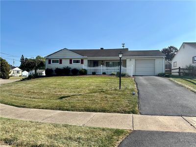 Single story home with a garage and a front yard | Image 1