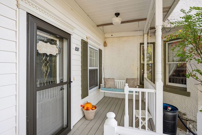 Additional seating with the porch swing on the opposite side of the porch offers plenty of room for company. | Image 7