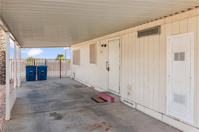 View of carport and fenced in backyard. | Image 30