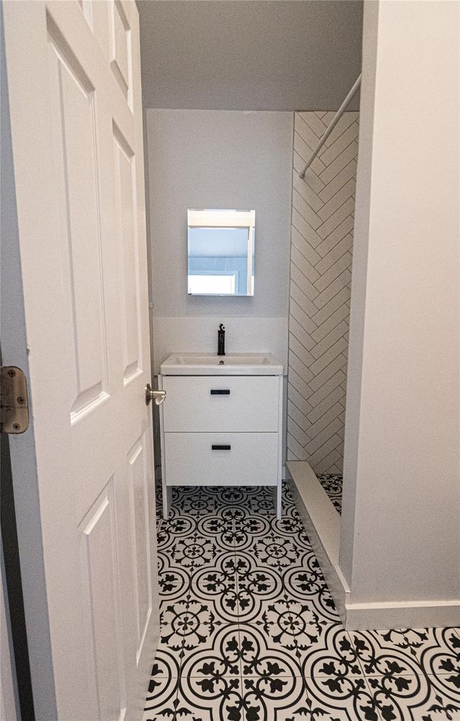 Full bathroom with tiled shower and a sink | Image 10