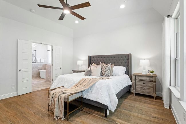 Bedroom featuring lofted ceiling, wood finished floors, recessed lighting, ensuite bathroom, and ceiling fan | Image 16
