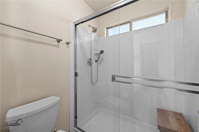 Bathroom with a tile shower and toilet | Image 35