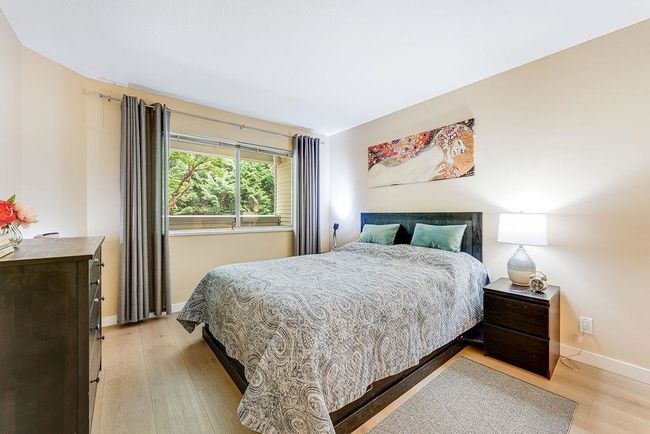 Bedroom featuring light wood-style floors and baseboards | Image 16
