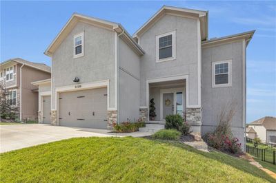 View of front of property featuring a garage and a front yard | Image 3