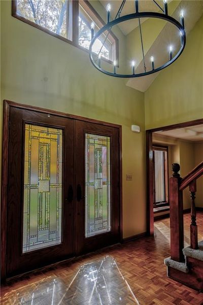 Entrance foyer with parquet flooring, french doors, and high vaulted ceiling | Image 3