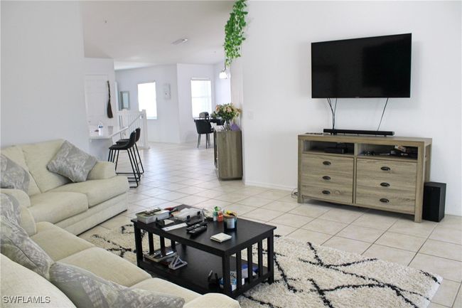 Living room with light tile patterned floors | Image 8